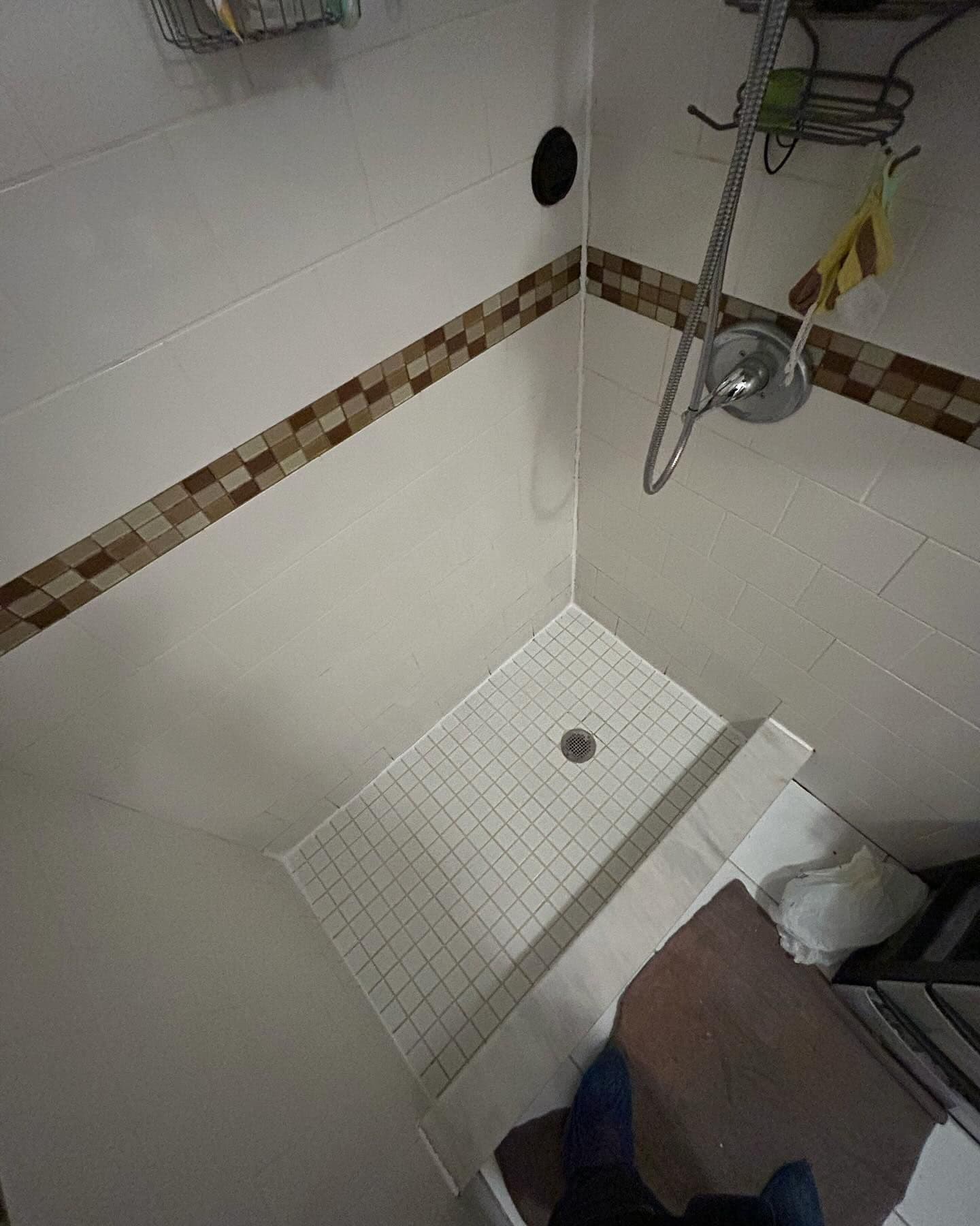 Bright white grout lines in a freshly cleaned tile shower